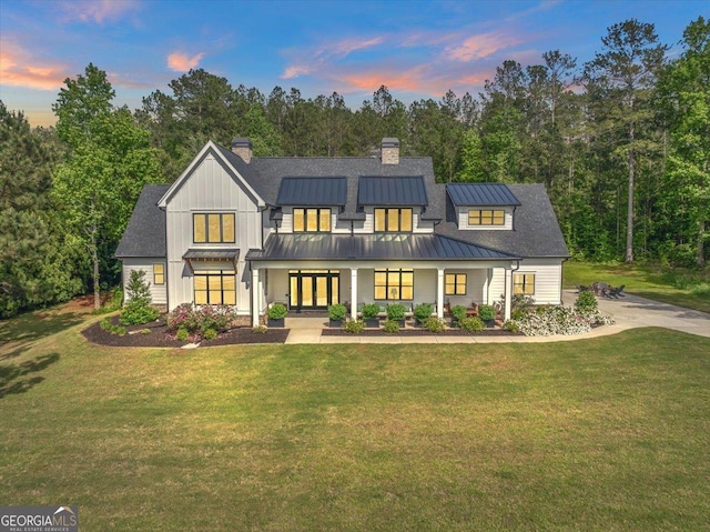 205 River Forest Dr, Forsyth, GA 31029 - view of front of house featuring a standing seam roof, a chimney, a yard, and french doors