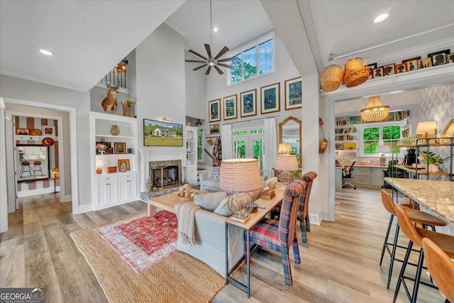 205 River Forest Dr, Forsyth, GA 31029 - living area with a ceiling fan, high vaulted ceiling, baseboards, light wood finished floors, and a glass covered fireplace