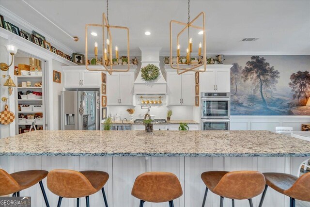 205 River Forest Dr, Forsyth, GA 31029 - kitchen with visible vents, crown molding, custom exhaust hood, a chandelier, and stainless steel appliances