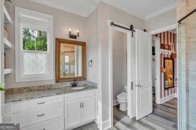 205 River Forest Dr, Forsyth, GA 31029 - bathroom featuring crown molding, vanity, wood finished floors, toilet, and baseboards