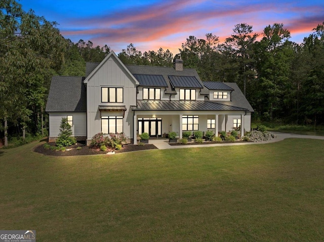 205 River Forest Dr, Forsyth, GA 31029 - modern inspired farmhouse with a lawn, metal roof, a chimney, and a standing seam roof