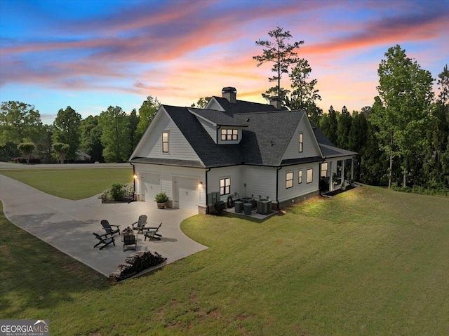 205 River Forest Dr, Forsyth, GA 31029 - rear view of property featuring an outdoor fire pit, a chimney, cooling unit, a patio area, and a lawn