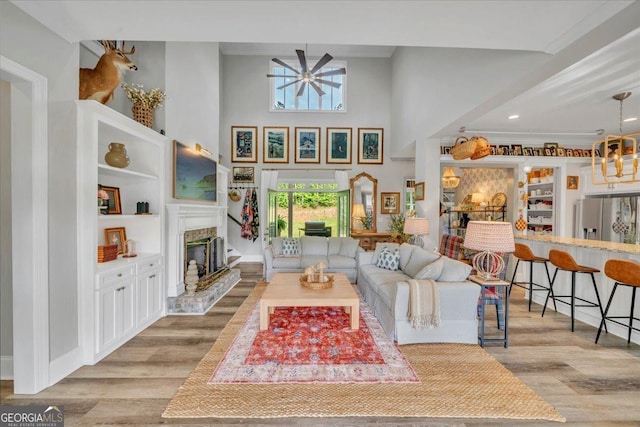 205 River Forest Dr, Forsyth, GA 31029 - living room with recessed lighting, a glass covered fireplace, wood finished floors, and a towering ceiling