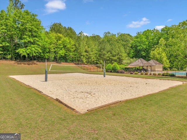 205 River Forest Dr, Forsyth, GA 31029 - view of home's community with a lawn, fence, a gazebo, and volleyball court