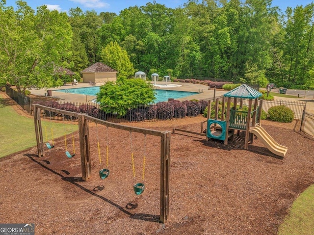 205 River Forest Dr, Forsyth, GA 31029 - community playground featuring fence, a community pool, and a patio