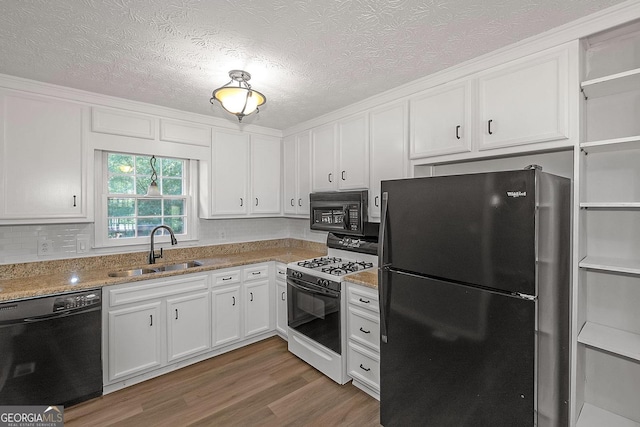 304 N Briar Rdg, Woodstock, GA 30189 - kitchen with wood finished floors, white cabinetry, light stone counters, a sink, and black appliances