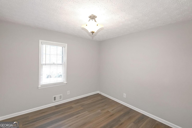 304 N Briar Rdg, Woodstock, GA 30189 - empty room with baseboards, visible vents, a textured ceiling, and dark wood-type flooring