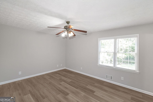 304 N Briar Rdg, Woodstock, GA 30189 - unfurnished room featuring visible vents, a ceiling fan, baseboards, and dark wood-type flooring