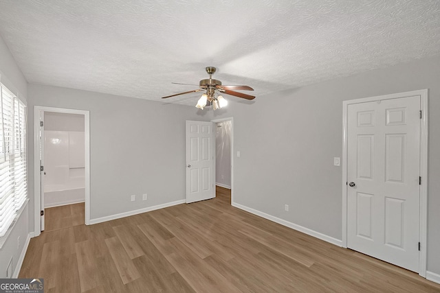 304 N Briar Rdg, Woodstock, GA 30189 - unfurnished bedroom featuring a ceiling fan, a textured ceiling, baseboards, and light wood-style floors