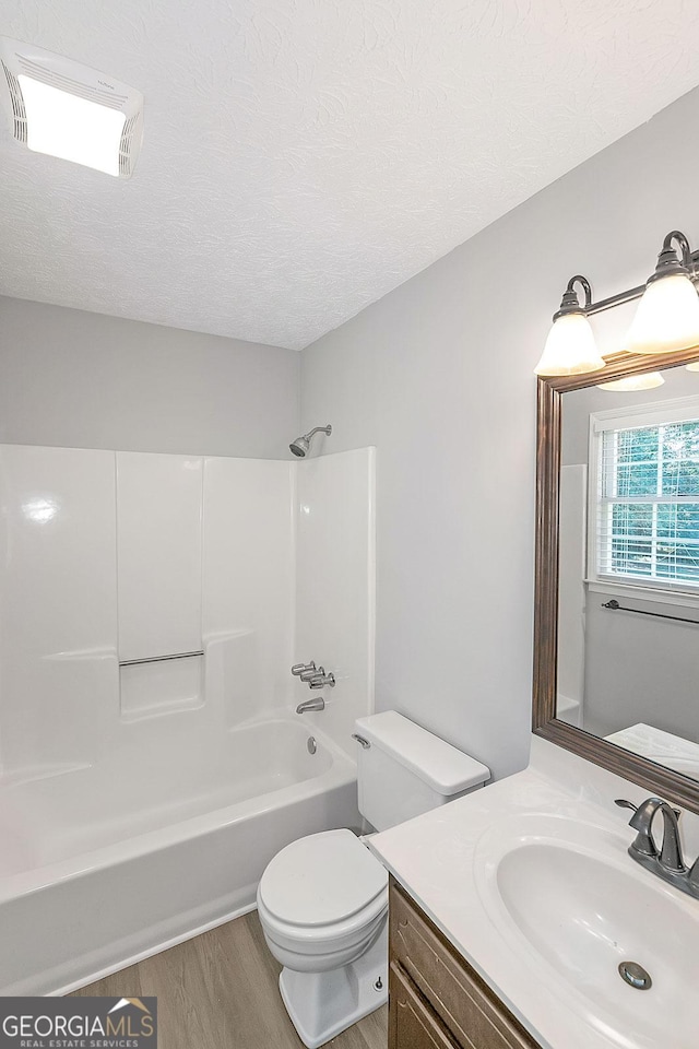 304 N Briar Rdg, Woodstock, GA 30189 - bathroom with a textured ceiling, wood finished floors, vanity, toilet, and  shower combination