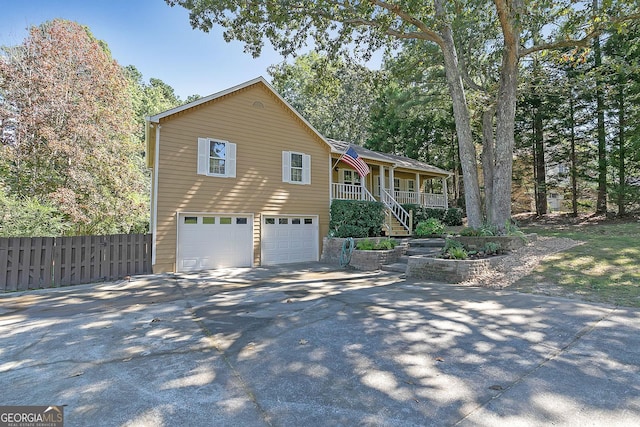 304 N Briar Rdg, Woodstock, GA 30189 - split foyer home with fence, an attached garage, stairway, covered porch, and driveway