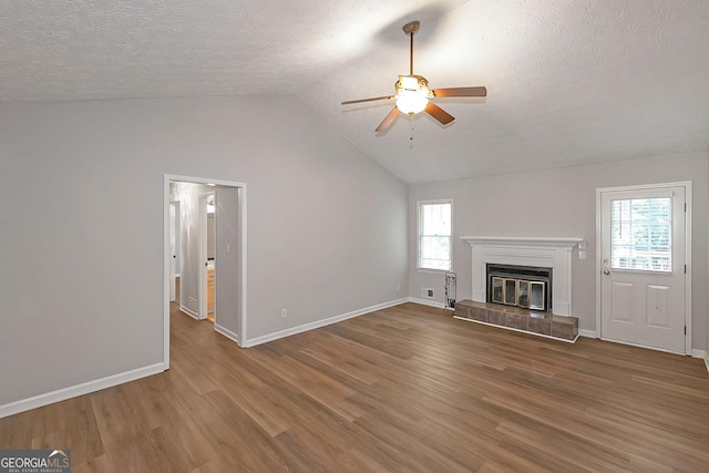 304 N Briar Rdg, Woodstock, GA 30189 - unfurnished living room with a ceiling fan, a textured ceiling, a healthy amount of sunlight, and wood finished floors