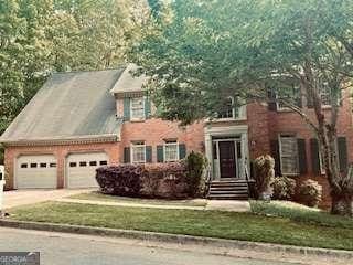 colonial home with concrete driveway and a garage