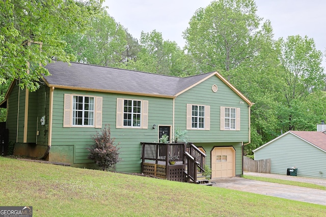 view of front of house featuring a front yard, concrete driveway, and an attached garage