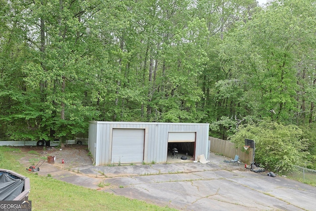 detached garage featuring fence