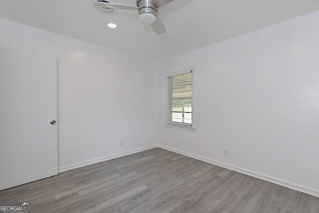 empty room featuring recessed lighting, a ceiling fan, wood finished floors, and baseboards