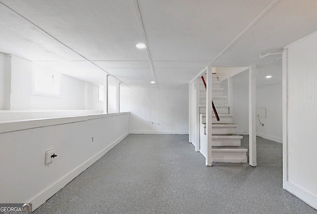 below grade area featuring recessed lighting, stairs, and baseboards