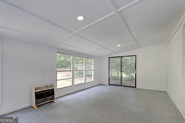 interior space featuring baseboards, recessed lighting, heating unit, and lofted ceiling