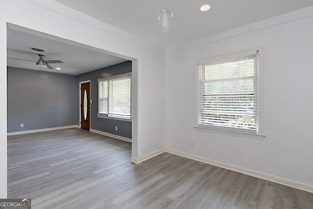 spare room featuring recessed lighting, ceiling fan, wood finished floors, and baseboards