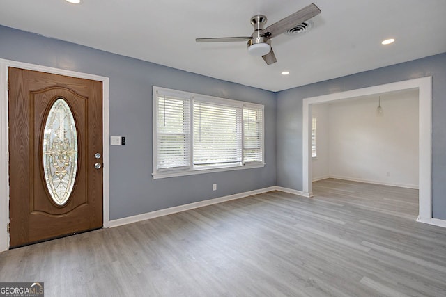 entrance foyer with wood finished floors, a ceiling fan, visible vents, and baseboards