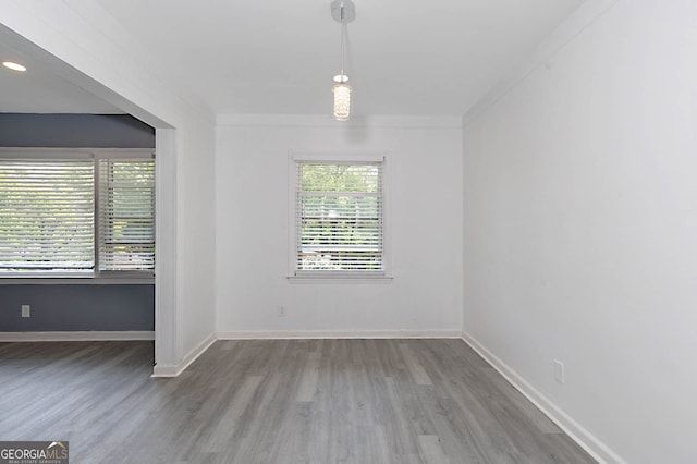 empty room featuring wood finished floors and baseboards