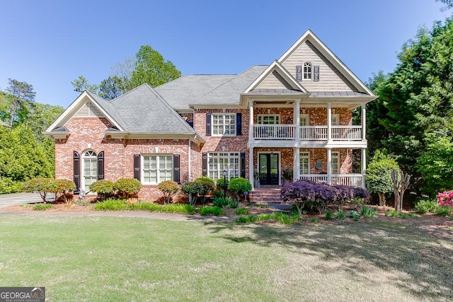 2930 Aquitania Ln, Cumming, GA 30040 - view of front of house featuring a front lawn, covered porch, a balcony, and brick siding