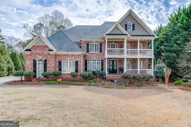 2930 Aquitania Ln, Cumming, GA 30040 - view of front of house with covered porch, brick siding, french doors, and a balcony
