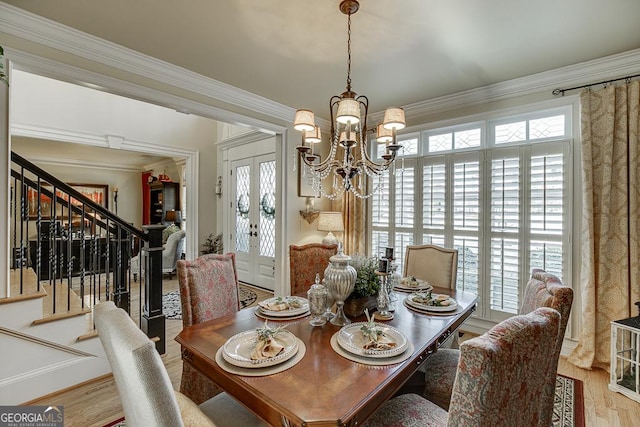2930 Aquitania Ln, Cumming, GA 30040 - dining space featuring ornamental molding, a notable chandelier, stairway, and a wealth of natural light
