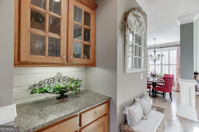 2930 Aquitania Ln, Cumming, GA 30040 - bar with a chandelier, pendant lighting, and crown molding