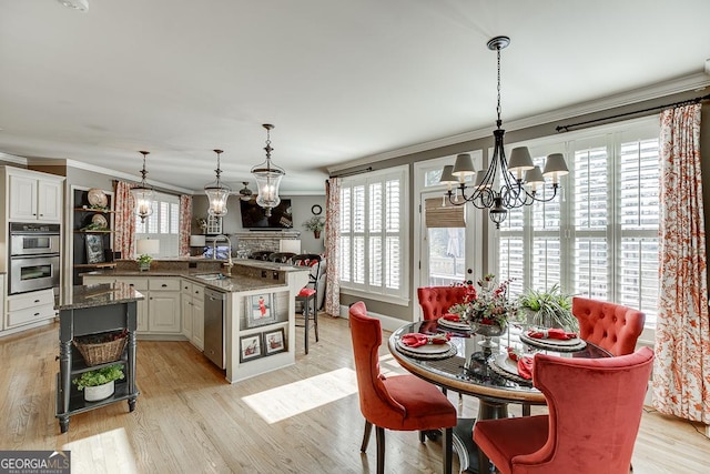 2930 Aquitania Ln, Cumming, GA 30040 - kitchen with ornamental molding, a notable chandelier, appliances with stainless steel finishes, and a sink