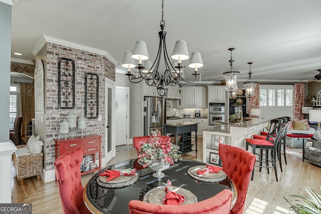 2930 Aquitania Ln, Cumming, GA 30040 - dining area featuring crown molding, light wood-style flooring, and ceiling fan with notable chandelier