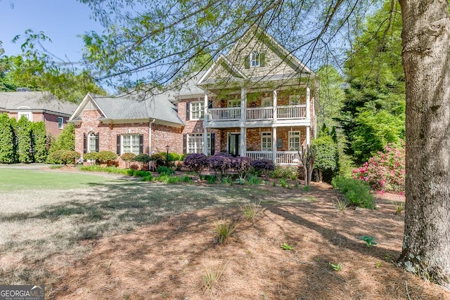 2930 Aquitania Ln, Cumming, GA 30040 - view of front of home featuring brick siding, covered porch, and a balcony