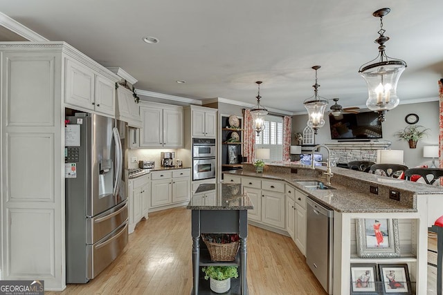 2930 Aquitania Ln, Cumming, GA 30040 - kitchen with ornamental molding, appliances with stainless steel finishes, a large island with sink, and a sink