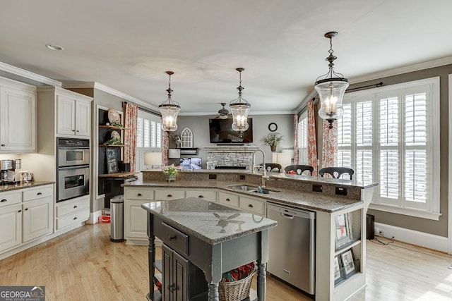 2930 Aquitania Ln, Cumming, GA 30040 - kitchen featuring a center island, light wood finished floors, a sink, and stainless steel appliances