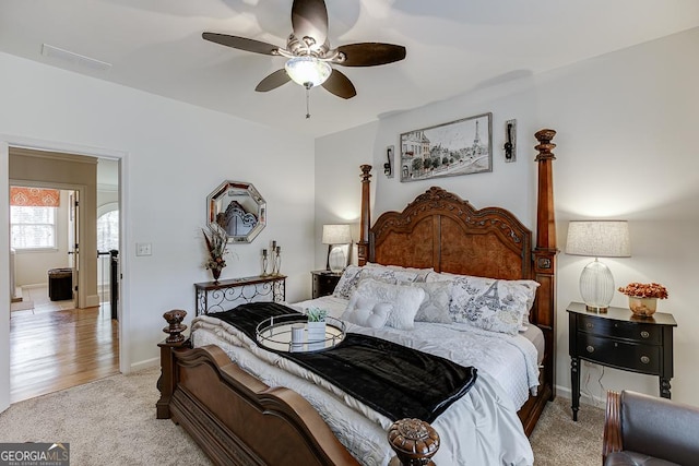 2930 Aquitania Ln, Cumming, GA 30040 - bedroom with light colored carpet, visible vents, a ceiling fan, and baseboards