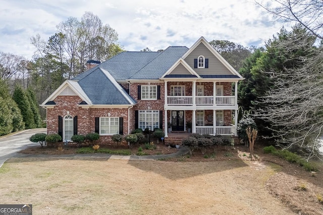 2930 Aquitania Ln, Cumming, GA 30040 - neoclassical home featuring covered porch, a balcony, a chimney, and brick siding