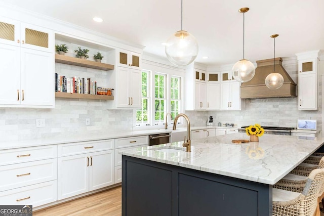 3380 Hill Forest Trl NW, Acworth, GA 30101 - kitchen featuring premium range hood, white cabinets, a kitchen island with sink, and tasteful backsplash