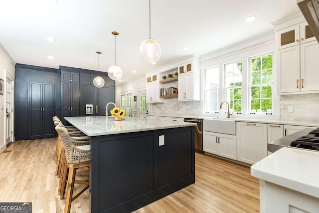 3380 Hill Forest Trl NW, Acworth, GA 30101 - kitchen with stainless steel dishwasher, a sink, light wood-type flooring, and tasteful backsplash