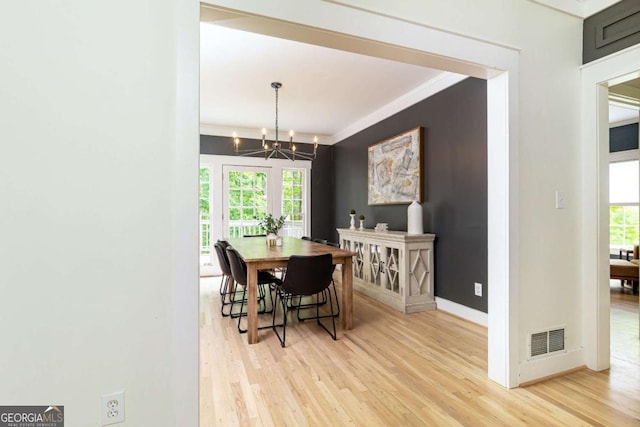3380 Hill Forest Trl NW, Acworth, GA 30101 - dining room with visible vents, crown molding, baseboards, light wood-type flooring, and a chandelier