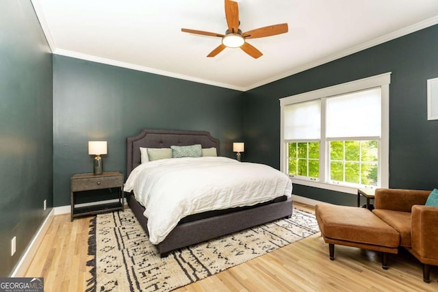 3380 Hill Forest Trl NW, Acworth, GA 30101 - bedroom featuring baseboards, ornamental molding, a ceiling fan, and light wood-style flooring