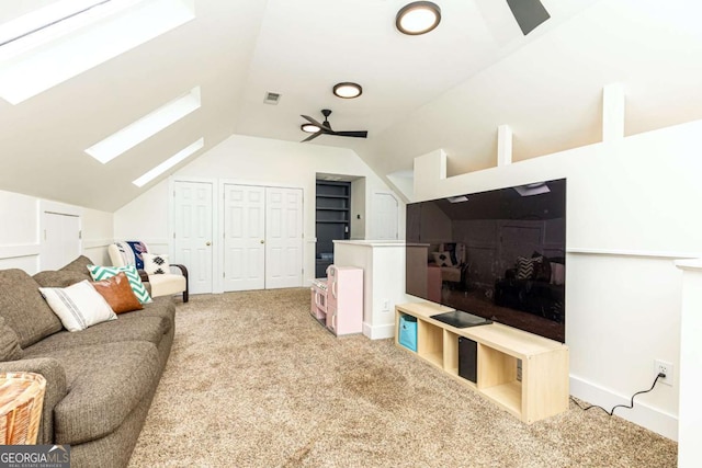 3380 Hill Forest Trl NW, Acworth, GA 30101 - living area featuring carpet floors, ceiling fan, visible vents, and vaulted ceiling with skylight