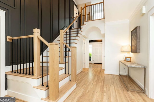 3380 Hill Forest Trl NW, Acworth, GA 30101 - stairs featuring arched walkways, baseboards, wood finished floors, and a high ceiling