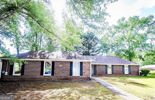 7415 Sierra Dr, Columbus, GA 31904 - ranch-style house featuring a front yard, a shingled roof, and brick siding