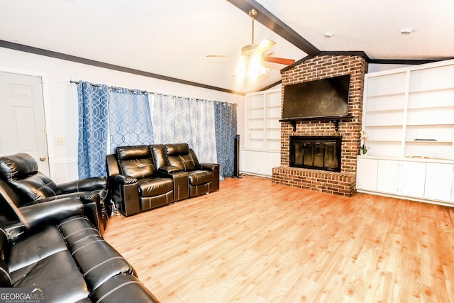 7415 Sierra Dr, Columbus, GA 31904 - living room featuring lofted ceiling with beams, a fireplace, wood finished floors, a ceiling fan, and built in features