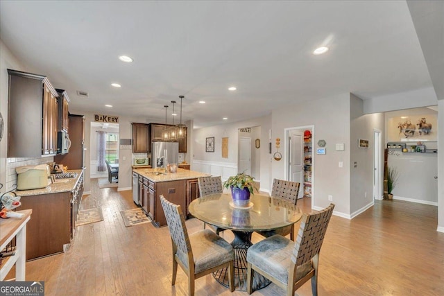 dining area featuring recessed lighting and light wood-style floors