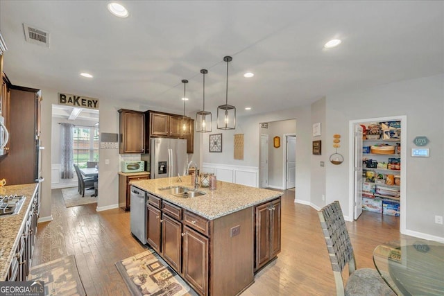 kitchen with light wood-style flooring, a sink, appliances with stainless steel finishes, and visible vents