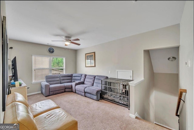 living area featuring ceiling fan, carpet flooring, and baseboards