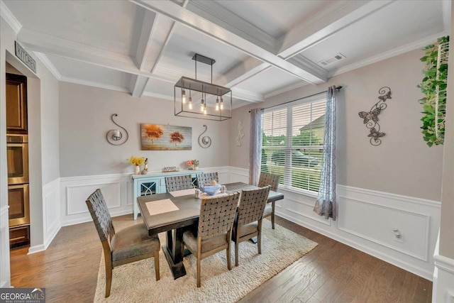 dining space with visible vents, beamed ceiling, coffered ceiling, and wood-type flooring