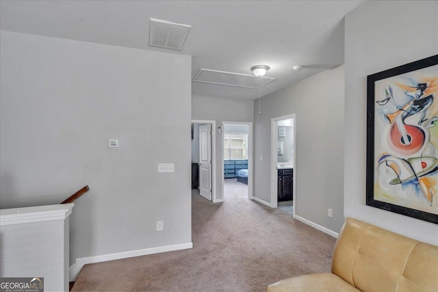 corridor featuring an upstairs landing, visible vents, baseboards, attic access, and carpet