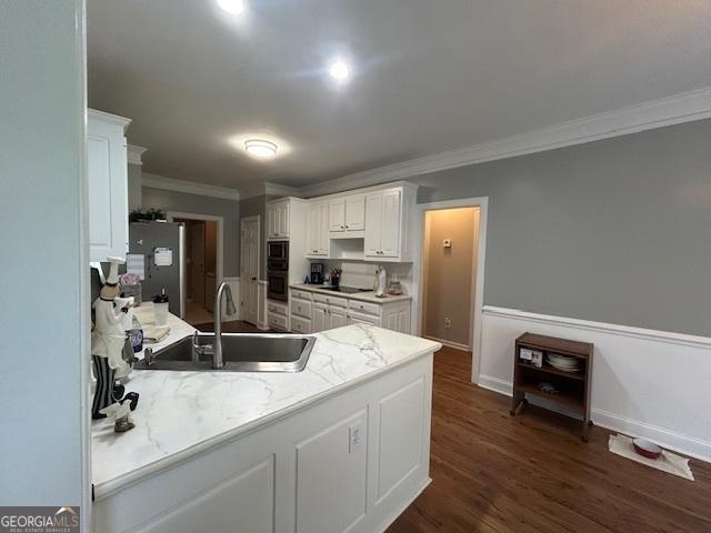 4665 Oakmont Bend Dr, Alpharetta, GA 30004 - kitchen featuring a sink, ornamental molding, freestanding refrigerator, black electric cooktop, and white cabinets